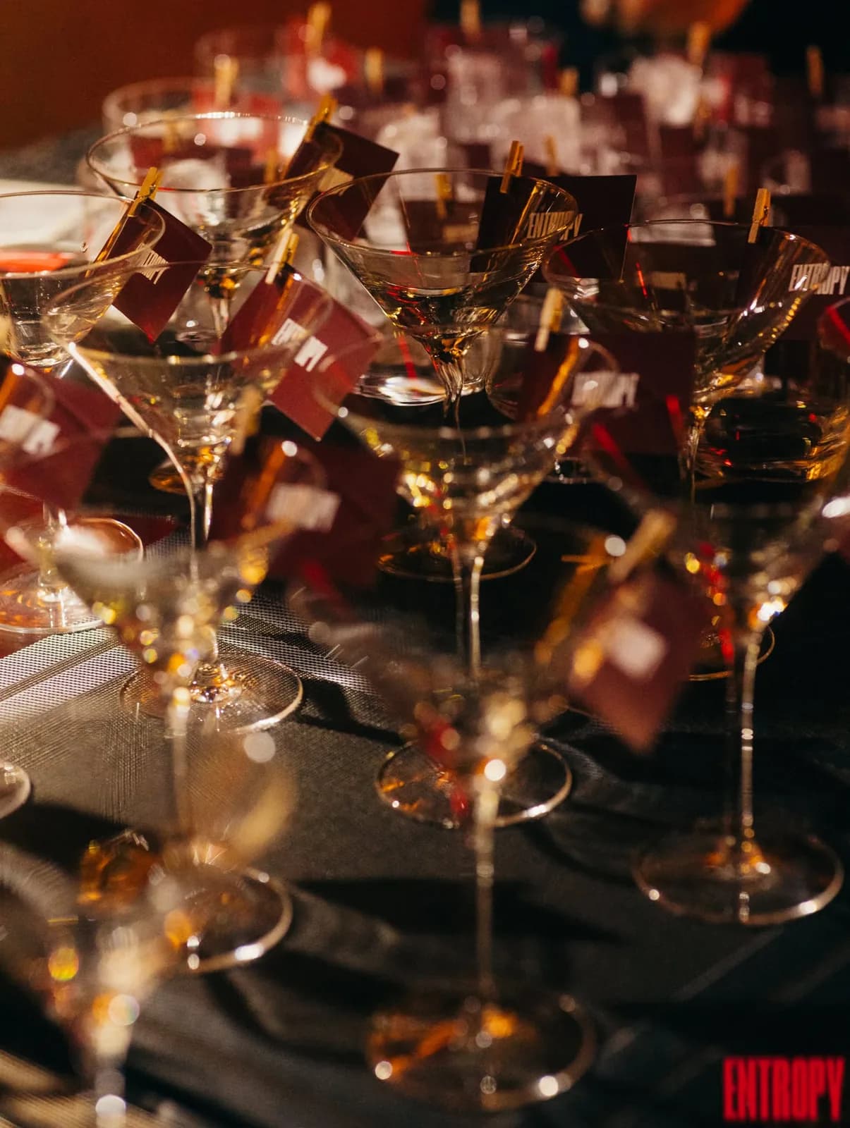 Signature cocktails lined up and flagged at the bar