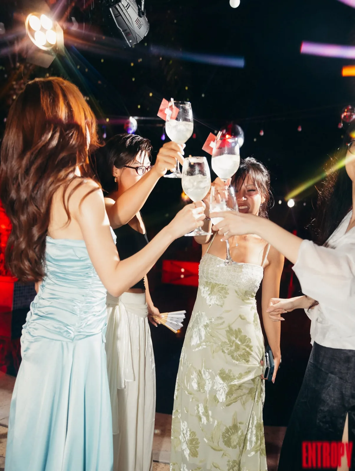 Guests raising glasses on the dance floor