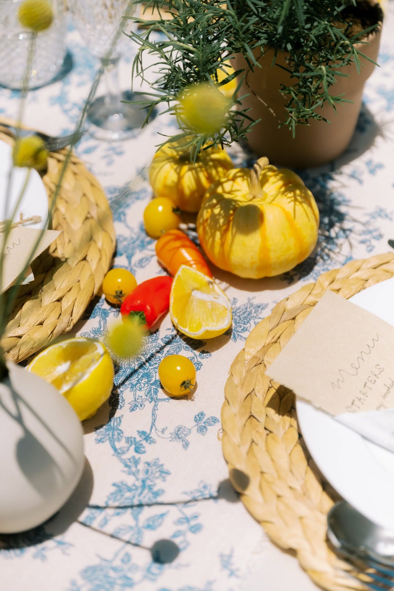 Styled table details — produce, woven chargers and hand-written menus